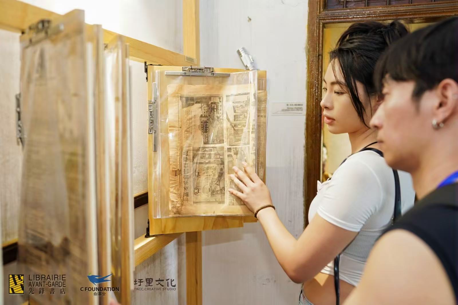 Mengruo Wang examining displayed printed material