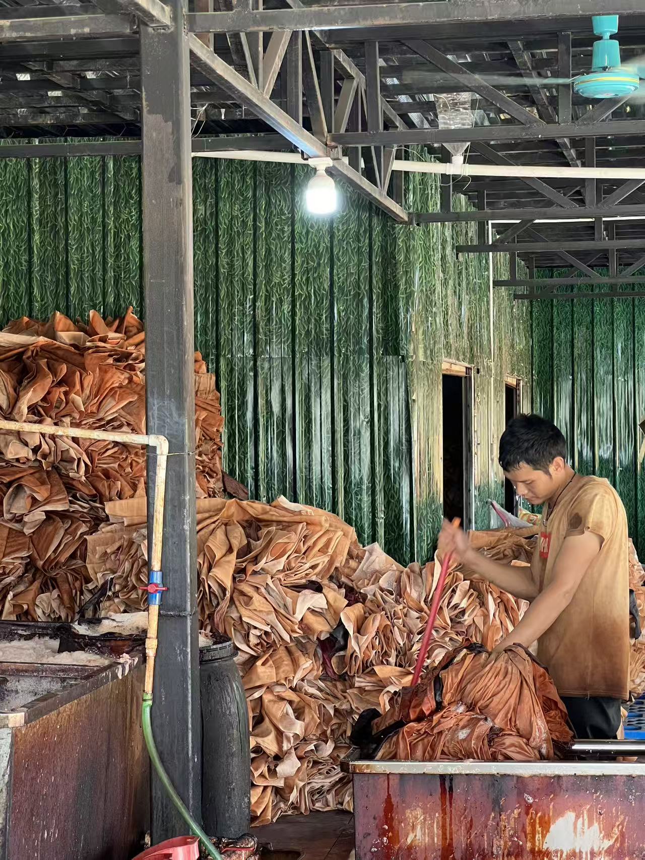 A textile worker handling dyed Xiangyunsha fabric