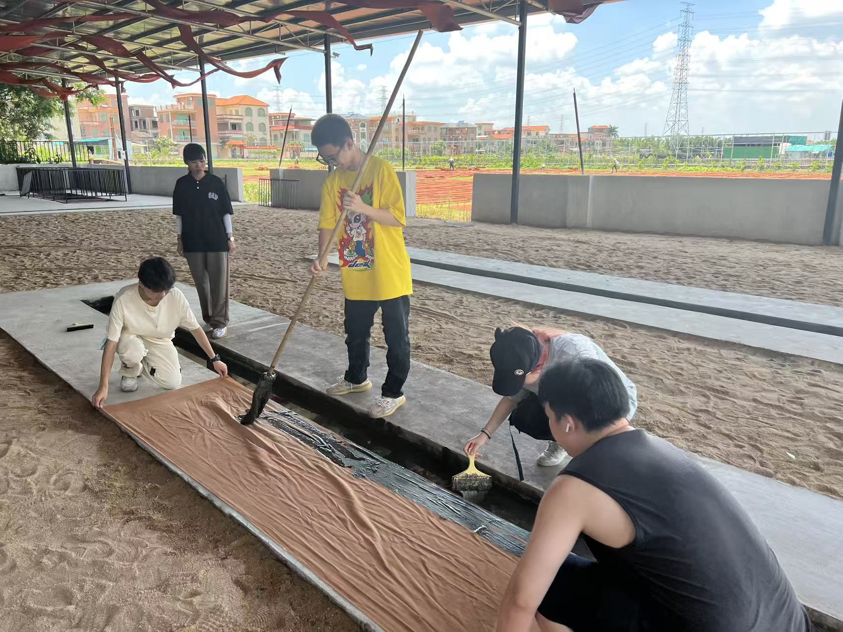 Participants working together with a long piece of brown fabric