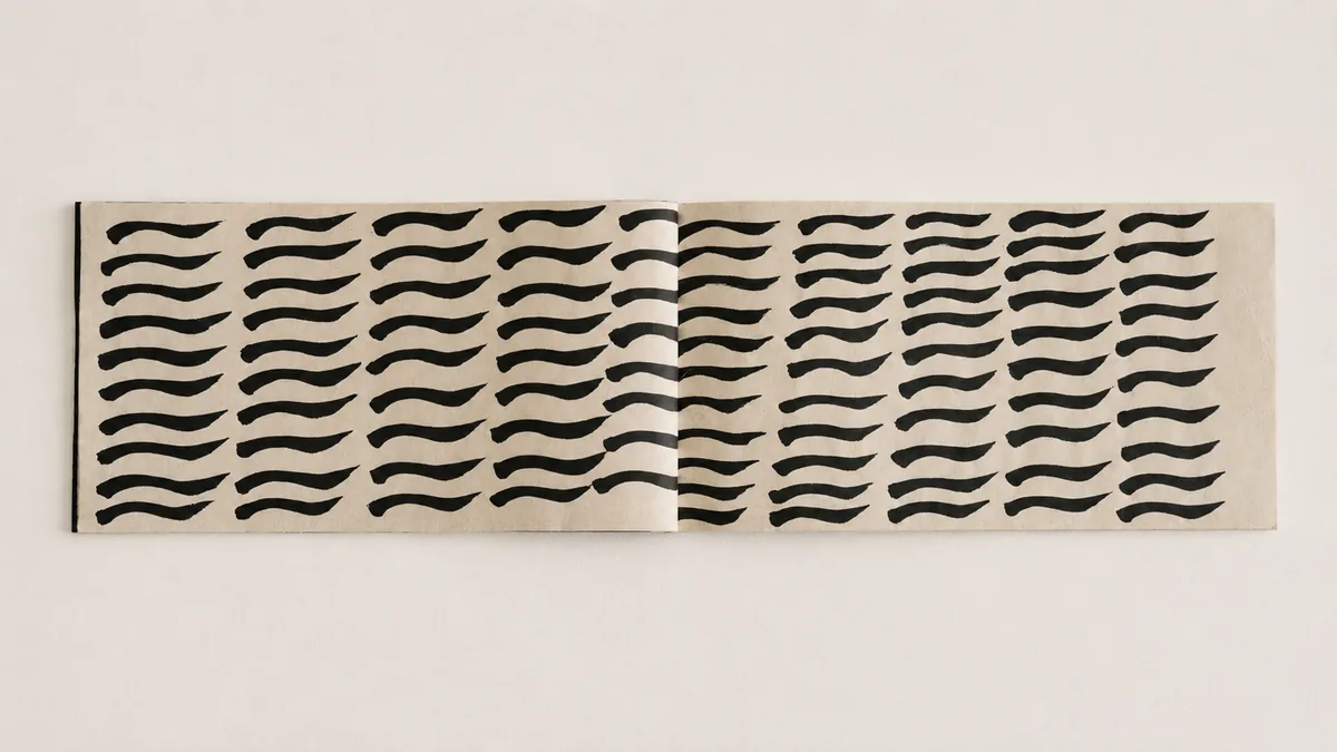 Interior spread showing repeated calligraphic marks.