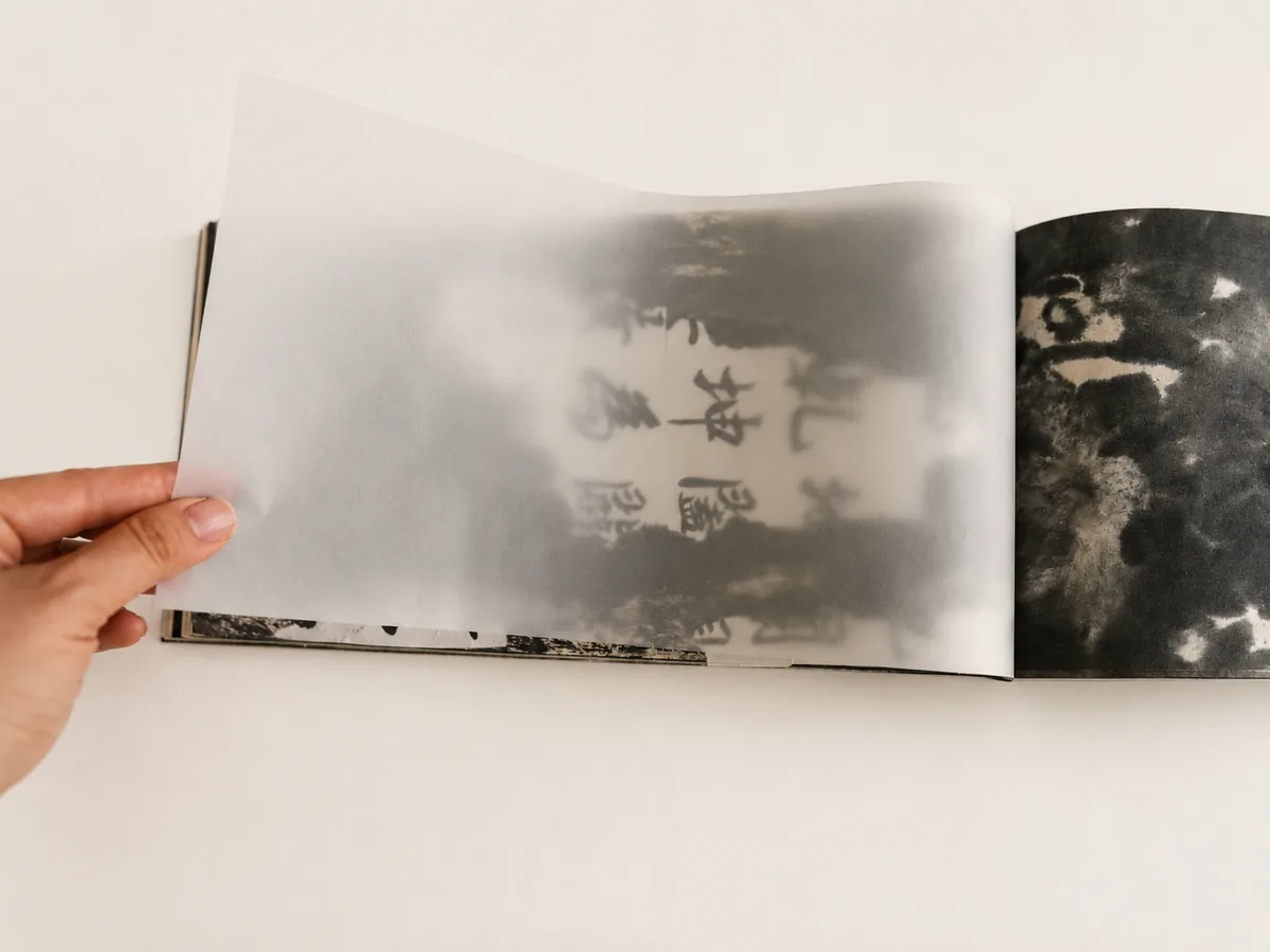 Interior detail showing translucent tracing paper over an inked page.